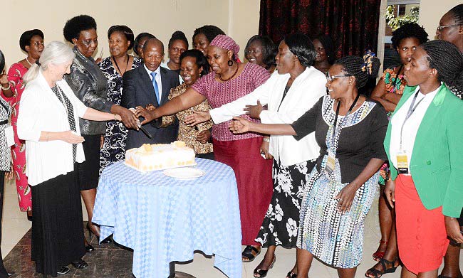 Guest of Honour-Hon. Dr. John Chrysostom Muyingo (3rd L) is joined by Dr. Euzobia Mugisha Baine (5th L), Ms. Naomi Lumutenga (2nd L), Prof. Catherine Hawkins (L) and other facilitators and participants to cut the HERS-EA Second Academy commemorative cake, 6th July 2018, Grand Global Hotel, Kampala Uganda