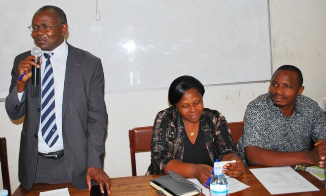 Principal-Prof. Bernard Bashaasha (L) addresses the students as the Finance Team Leader Mrs. Vianney Baguma and the College Librarian Mr. Onan Mulumba listen, 8th August 2018, CAES, Makerere University, Kampala Uganda