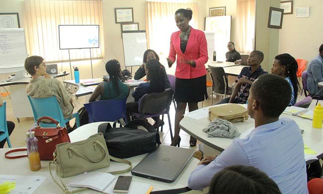 RAN's Communications Manager-Harriet Adong (Standing) briefs some of the interns during the joint meeting on 31st May 2018, RAN Offices, Upper Kololo Terrace, MakSPH, Makerere University, Kampala Uganda