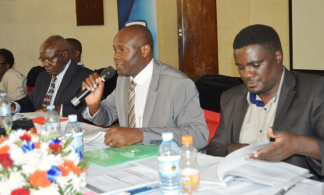 MURBS Chairperson Board of Trustees-Mr. Wilber Grace Naigambi (C) flanked by Audit Committee Chairperson-Mr. David Ssenoga (L) and Secretary BoT-Dr. John Kitayimbwa (R) at the 8th AGM on 24th October 2018, Main Hall, Makerere University, Kampala Uganda