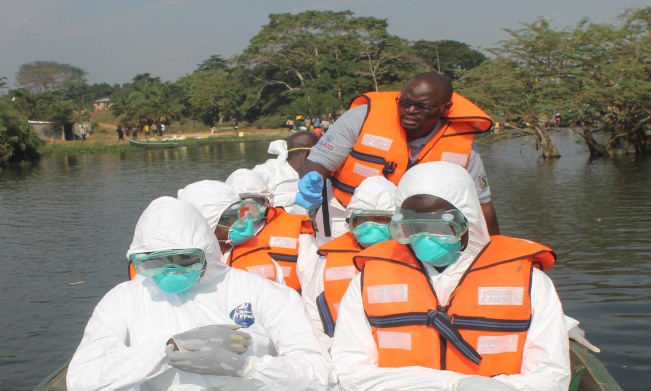 Student Responders on a boat off Lutembe Beach wearing Personal Protective Equipment (PPE) go out on the lake to collect a dead bird during the Highly Pathogenic Avian Influenza outbreak in February 2017 Image:OHCEA