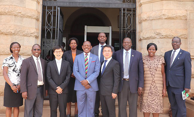 The Vice Chancellor-Prof. Barnabas Nawangwe (4th L) and Assoc. Prof. Huang Yu (3rd L) are joined by L-R: Ms. Ritah Namisango, Prof. Peter Atekyereza, Ms. Martha Muwanguzi (Rear), Dr. Vincent Ssembatya (Rear), Zhang Pengbin, Prof. Tonny Oyana, Dr. Ruth Nalumaga and Mr. Walter Yorac Nono in a group photo after the MoU signing on 8th October 2018, Makerere University, Kampala Uganda
