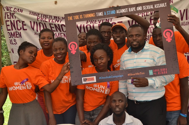 Mr. Eric Tumwesigye together with some of the participants posing for a photo with a plaque card.