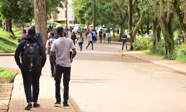 Students stroll along Lincoln Close on the Main Campus, Makerere University, Kampala Uganda