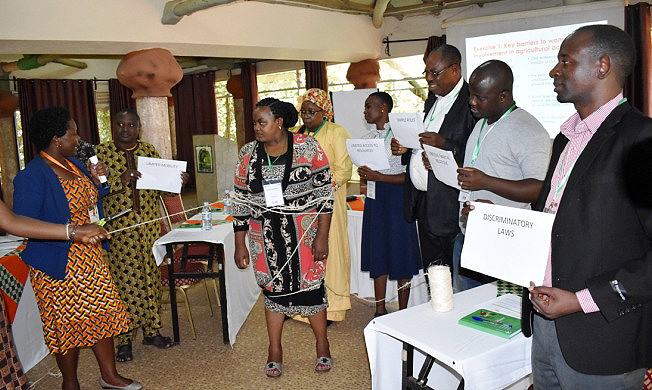 Participants engage in role play to illustrate barriers to women's active participation in agricultural activities during the GREAT TLIII Course on 26th November 2018, Forest Cottages, Bukoto Kampala, Uganda.