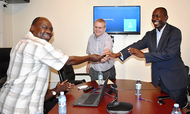 Mak's Head-DANRE, Dr. Gabriel Elepu (L) receives keys to the Video Conferencing Facility from Prof. Allen Featherstone (C) and Dr. Simon Byabagambi (L) on 16th November 2018, CAES, Makerere University, Kampala Uganda. The US$9k Facility was donated under a USAID Capacity Building Project