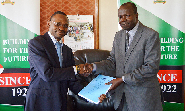 Dr. Umar Kakumba (Left) the incoming First Deputy Vice Chancellor (Academic Affairs) receives a copy of the outgoing First Deputy Vice Chancellor Academic Affairs Dr. Ernest Okello Ogwang's report on 30th November 2018, Makerere University, Kampala Uganda.