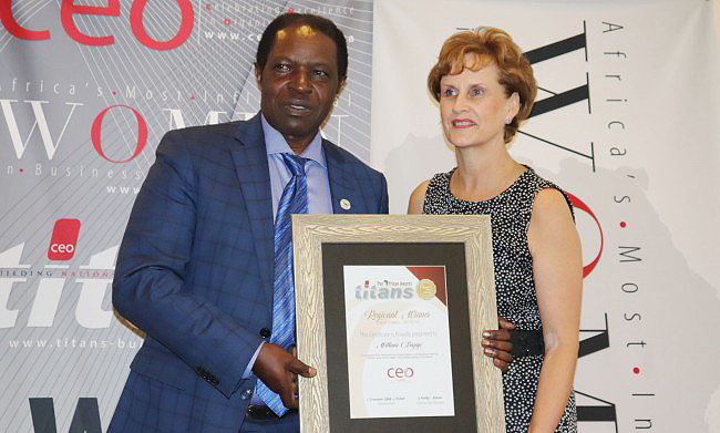 The Acting DVCFA-Prof. William Bazeyo (Left) poses with his award with CEO Global's Chief Executive-Annelize Wepener (Right) on 3rd November 2018, Protea Hotel, Kampala Uganda.