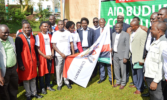 The Vice Chancellor-Prof. Barnabas Nawangwe (holding flag) and Chairperson MUASA-Dr. Deus Kamunyu Muhwezi (to his right) flanked by Members of Management, MUASA Executive and students at the ABC Initiative Flag off Ceremony, 2nd November 2018, Freedom Square, Makerere University, Kampala Uganda