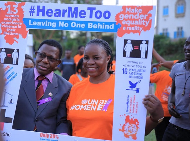 The Director of Research and Graduate Training at Makerere University, Prof. Buyinza Mukadasi together with the  program Specialist of UN Women-Uganda Ms. Susan Oregede posing for a photo with the HeforShe campaign plaque card.