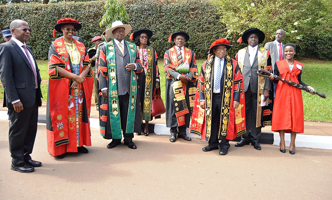 The President of the Republic of Uganda and Visitor of Makerere University-H.E. Yoweri Kaguta Museveni (3rd L), First Lady-Hon. Janet Kataaha Museveni (2nd L), Hon. Dr. John Chrysostom Muyingo (L), Chancellor-Prof. Ezra Suruma (3rd R), Chairperson Council-Mrs. Lorna Magara (C), Vice Chair-Rt. Hon. Daniel Fred Kidega (2nd R), Vice Chancellor-Prof. Barnabas Nawangwe (4th R) and the Mace bearer (R) on Day1 of the 69th Graduation Ceremony. President Museveni received Mak's Outstanding Scholarly Authorship Award