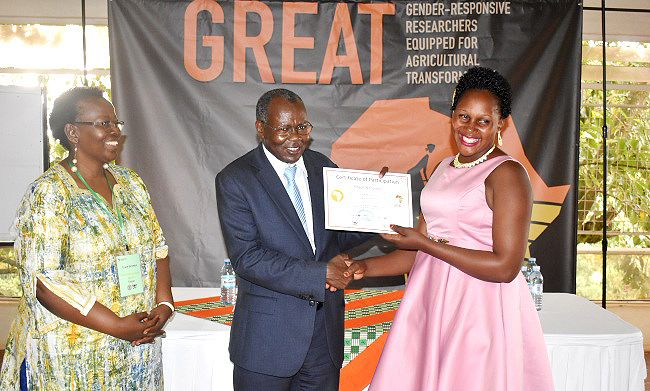 The Principal CAES-Prof. Bernard Bashaasha (C) hands over a certificate to NaCRRI's Grace Nanyonjo (R) as Prof. Grace Bantebya (L) witnesses at the conclusion GREAT Gender Responsive Course 3 Second Phase on Legumes, 18th January 2019, Forest Cottages, Bukoto, Kampala Uganda