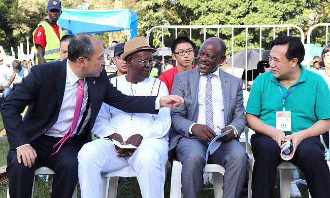 The Chinese Ambassador to Uganda-H.E. Zheng ZhuQiang (L) introduces one of the leaders of the Shaanxi Provincial Acrobatic Art Troupe (R) to the Minister of Tourism, Wildlife and Antiquities-Hon. Ephraim Kamuntu (2nd L) and the Vice Chancellor-Prof. Barnabas Nawangwe (2nd R) during the Chinese New Year Acrobatic Show, 26th January 2019, Freedom Square, Makerere University, Kampala Uganda