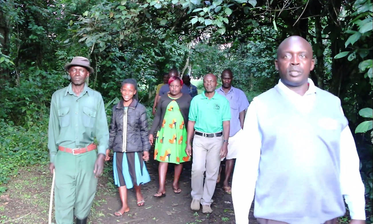 Acting Director, Makerere University Biological Field Station (MUBFS), SFEGS, CAES-Assoc. Prof. David Tumusiime (green t-shirt) takes a stroll with his staff at the Field Station, Kibale National Park, Fort Portal, Uganda