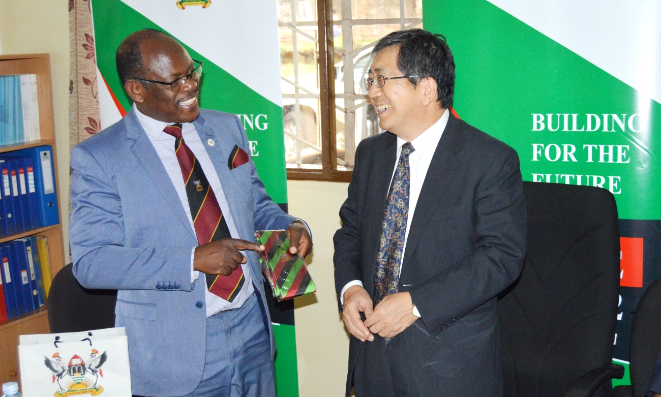 The Vice Chancellor, Prof. Barnabas Nawangwe (Left) presents the Mak necktie to Japanese Ambassador H.E. Kazuaki Kameda (Right) during his visit to the AICAD Uganda Country Office on 17th April 2019, Makerere University, Kampala Uganda