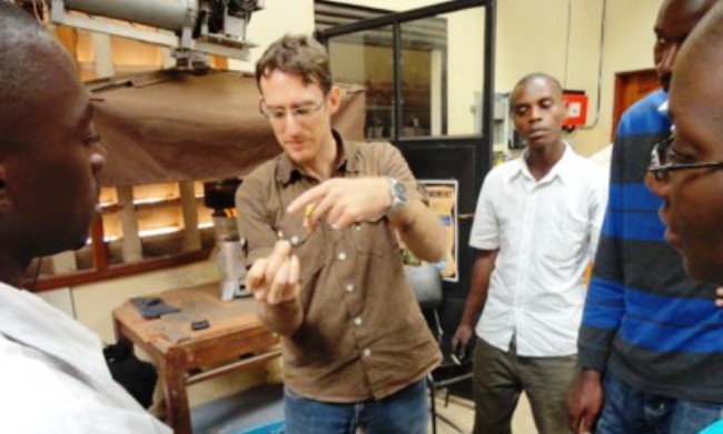 Stephen Christensen (2nd L) demonstrates biomass combustion at the Centre for Research in Energy and Energy Conservation (CREEC), CEDAT, Makerere University, Kampala Uganda