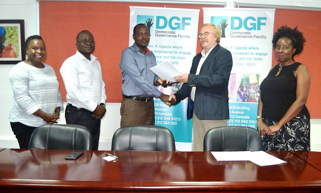 The Head Democratic Governance facility (DGF) Mr. Wim Stoffers (2nd Right) and Principal, School of Law Assoc.Prof. Christopher Mbazira (3rd Left) exchange the signed document after DGF awarded the School a two-year UGX2.2bn grant to the "Using Legal Education to Promote Public Interest Lawyering and Improve Access to Justice" Project in May 2019.