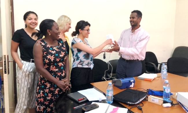 The BEHS Course Coordinator-Mr. Ali Halage (Right) receives air quality monitoring equipment from the SDSU Team on 30th May 2019 at MakSPH, Mulago, Makerere University, Kampala Uganda