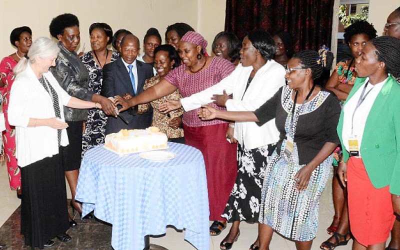 Guest of Honour-Hon. Dr. John Chrysostom Muyingo (3rd L) is joined by Dr. Euzobia Mugisha Baine (5th L), Ms. Naomi Lumutenga (2nd L), Prof. Catherine Hawkins (L) and other facilitators and participants to cut the HERS-EA Second Academy commemorative cake, 6th July 2018, Grand Global Hotel, Kampala Uganda