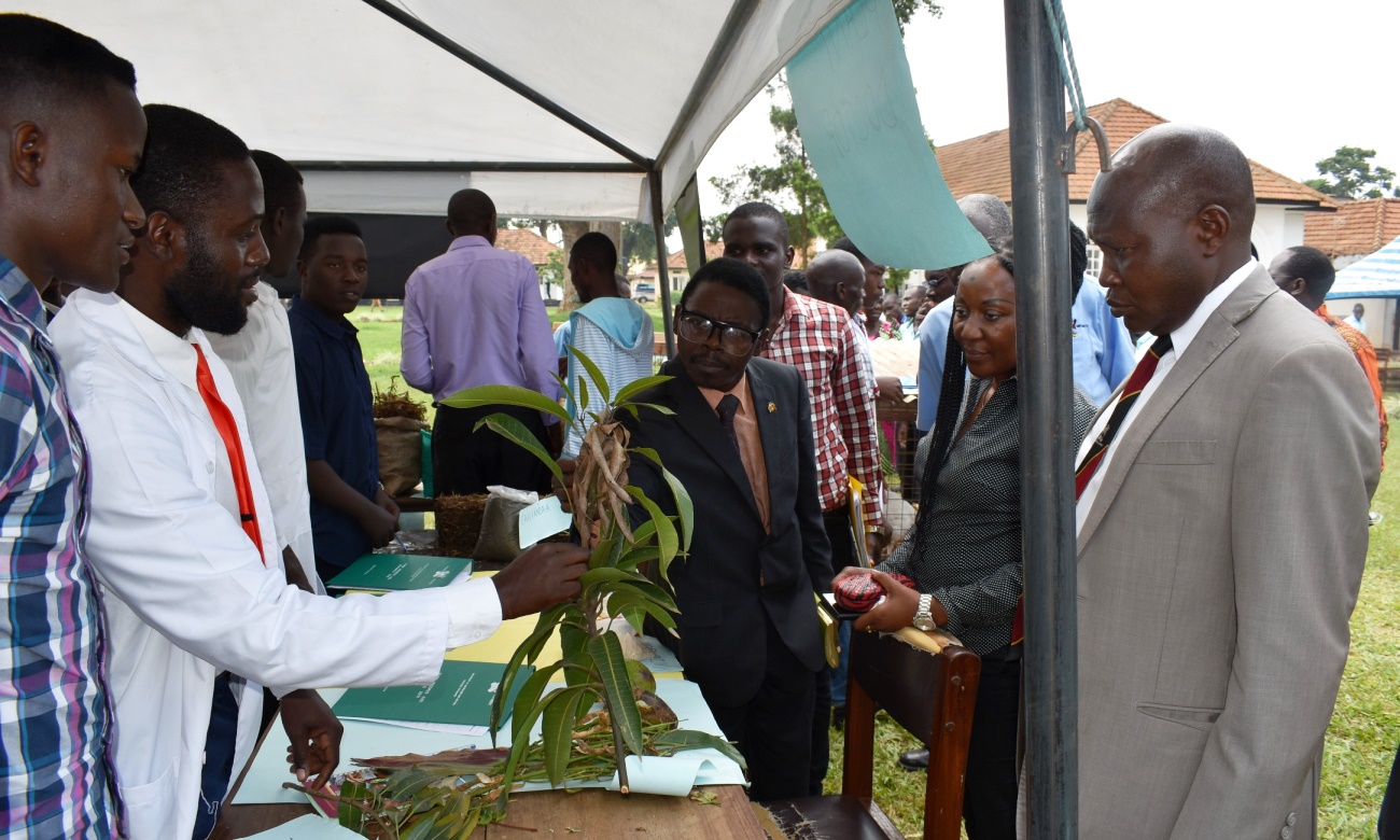 The Guest of Honor-Dr. Godfrey Lusiba Sebagala (3rd Right), CAES Deputy Principal-Dr. Gorettie Nabanoga (2nd Right) and Dr. David Owiny (Right) visit the plant doctors stall during the Field Day on 26th July 2019, MUARIK, CAES, Makerere University, Wakiso Uganda.