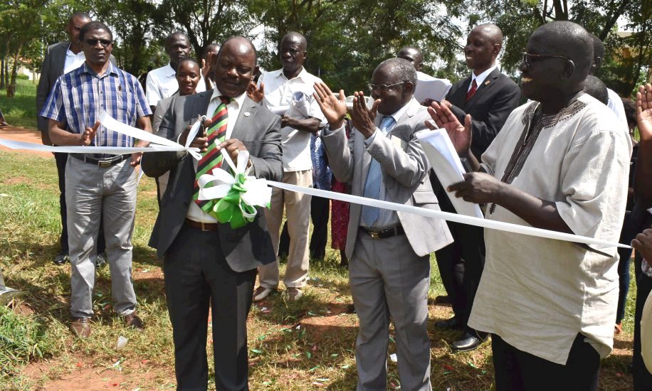 The Vice Chancellor, Prof. Barnabas Nawangwe cuts the tape marking the start of the construction of the UGX2.4bn MaRCCI Office block and Lecture Theatres under the World Bank ACEII project, 16th July 2019, MUARIK, Makerere University, Wakiso Uganda. Applauding are CAES Principal-Prof. Bernard Bashaasha (2nd R), MaRCCI PI-Dr. Richard Edema (R) and other officials.