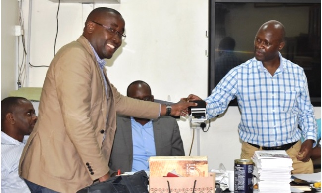 Assoc. Prof. Frank Mugagga (Left) receives instruments of power from Outgoing head Assoc. Prof. Yazidhi Bamutaze (Right) on 28th June 2019 in the Mountain Resource Center, Department of Geography, Geo informatics and Climatic sciences (GGCS), SFEGS, CAES, Makerere University, Kampala Uganda.