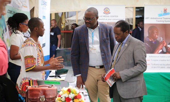 The RAN Chief of Party, Prof. William Bazeyo (Right) and the Permanent Secretary, Ministry ICT and National Guidance, Mr. Vincent Waiswa Bagiire (2nd Right) inspect one of the stalls at the ICT Innovation Katale on 5th July 2019, Hotel Africana, Kampala Uganda
