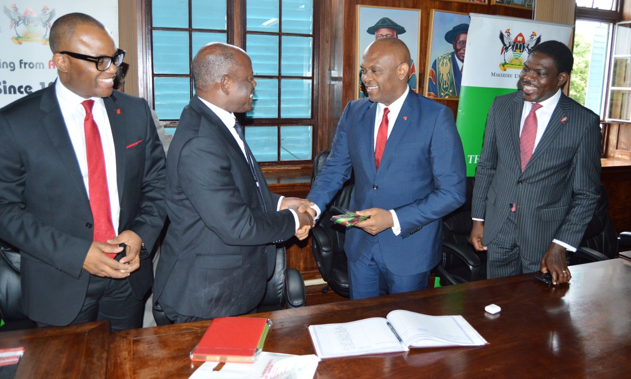 UBA Founder, Mr. Tony Elumelu (2nd Right) receives a Mak Necktie from the Vice Chancellor, Prof. Barnabas Nawangwe (2nd Left) during his visit to Makerere University, Kampala Uganda on 11th April 2018