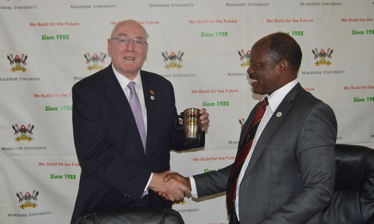 Prof. Barney Glover (Left) shows off the Mak mug received from the Vice Chancellor, Prof. Barnabas Nawangwe (Right) during his visit on 1st August 2019, Makerere University, Kampala Uganda