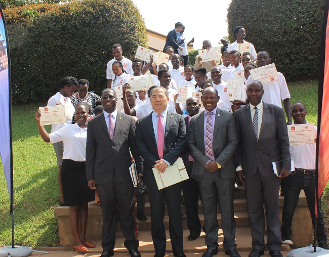 Scholars posing for a photo with H.E Zheng Zhuqiang,the Ambassador the ambassador of People's Republic of China, Mr. Aggrey David Kibenge, representing the Minister of Education and Sports and Prof. Barnabas Nawangwe, the Vice Chancellor of Makerere University.