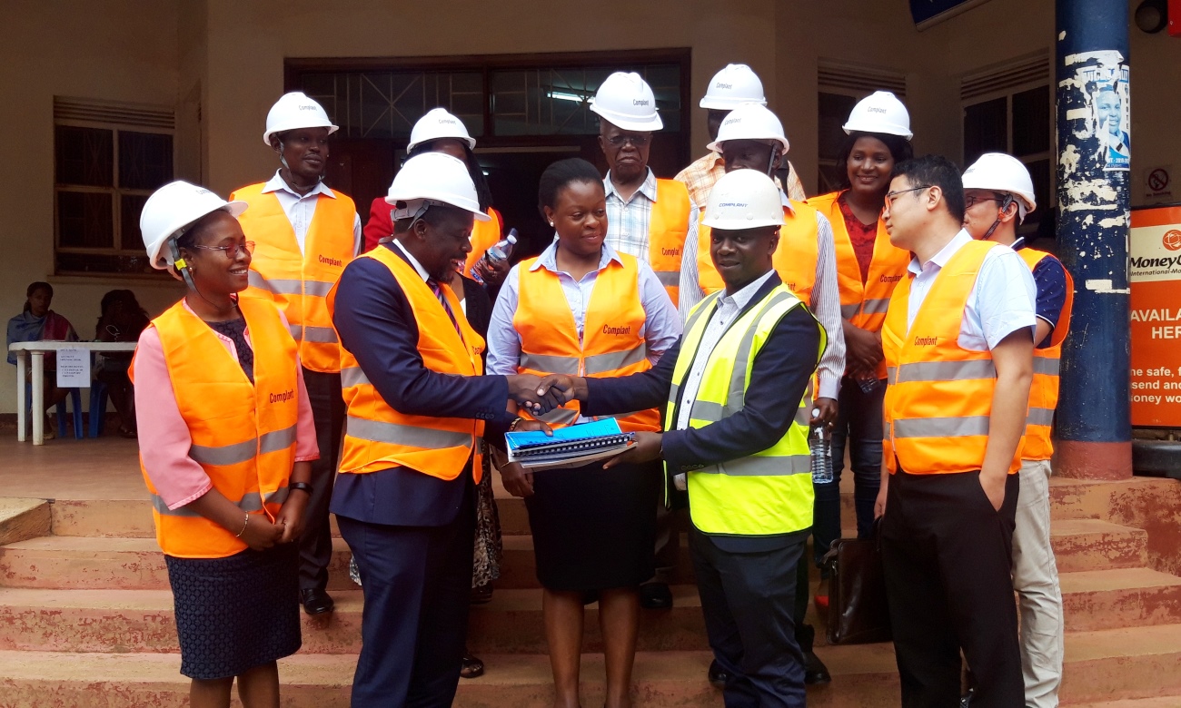 The Acting University Secretary-Mr. Yusuf Kiranda (2nd Left) hands over the SWGS Building Site to the Project Manager (2nd Right) as the Dean SWGS-Dr. Sarah Ssali (Left), Director EWD-Eng. Christina Kakeeto (Centre), Complant and Mak Staff witness on 26th August 2019, Makerere University, Kampala Uganda