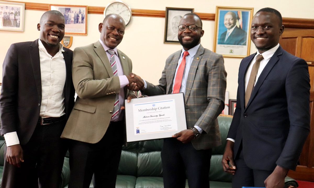 The Vice Chancellor, Prof. Barnabas Nawangwe (2nd Left) receives the United Nations Academic Impact (UNAI) Membership Citation from 84th Guild President, H.E. Papa Were Salim (2nd Right) as Mr. Silver Walugembe (Right) and Mr. Abdu Twaibu Magambo (Left) witness on 20th September 2019, Makerere University, Kampala Uganda