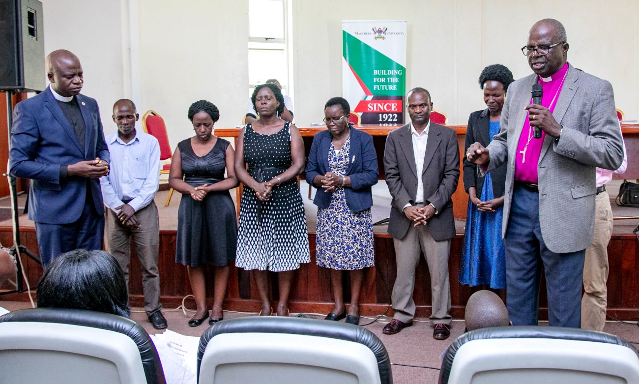 Archbishop Emeritus-Dr. Henry Luke Orombi (Right) and St. Francis Chaplain-Rev. Can. Onesimus Asiimwe (Left) pray for the Joint Staff Fellowship Steering Committee shortly after anointing the members on 13th September 2019, Makerere University, Kampala Uganda.