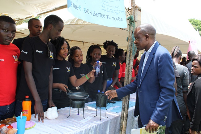 The Principal, College Business and Management Sciences Prof. Eria Hisali interacting with some of the exhibitors at  Makerere University Students Entreprenuership Expo on 11th October 2019.