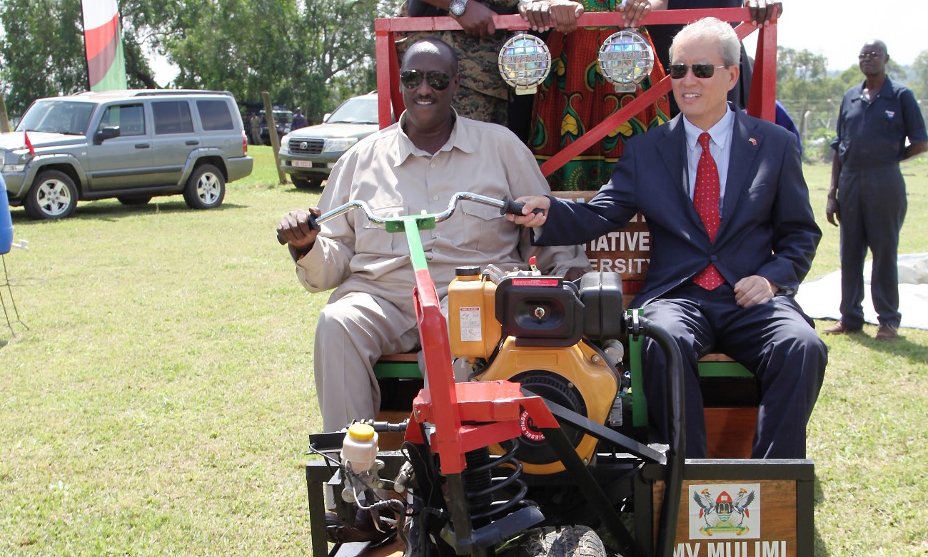 The Head of Operation Wealth Creation, Gen. Salim Saleh (Left) and the Chinese Ambassador- H.E. Zhao Yali (Right) test drive the MV Mulimi-a multipurpose vehicle capable of threshing maize, pumping water from a depth of 7metres to a height of 33metres, ploughing and transporting 20 adults and their goods. This was on 31st December 2015 at MUARIK, Makerere University, Wakiso Uganda.