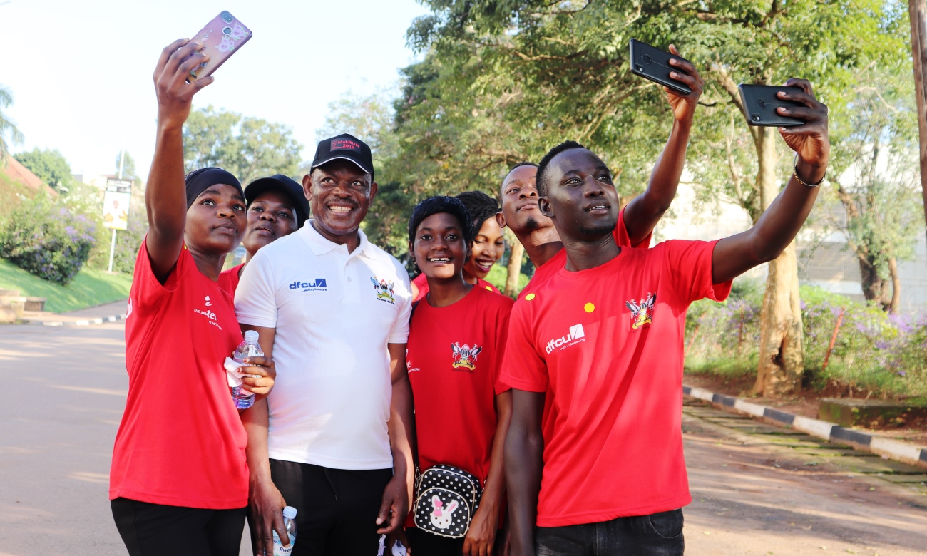 Students enjoy selfie moments with the Vice Chancellor, Prof. Barnabas Nawangwe (2nd Left) along University Road at the conclusion of the 5km route of MakRun2019 on 15th September 2019, Makerere University, Kampala Uganda. MakRun2019 raised over UGX100million shillings.