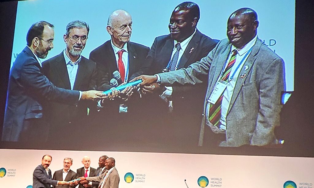 The Principal CHS-Prof. Charles Ibingira (Right) and Principal CoCIS-Prof. Tonny Oyana (2nd Right) receive the baton representing the World Health Summit International Presidency from Tehran University of Medical Sciences officials (Left) as Prof. Dr. Detlev Ganten, President of the World Health Summit (Centre) witnesses in Berlin, Germany on 28th October 2019.