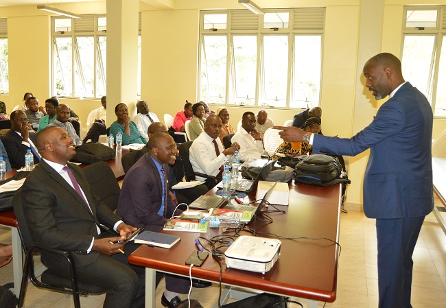 The Executive Director for National Planning Authority (NPA) Dr. Joseph Muvawala interacting with the PhD fellows.