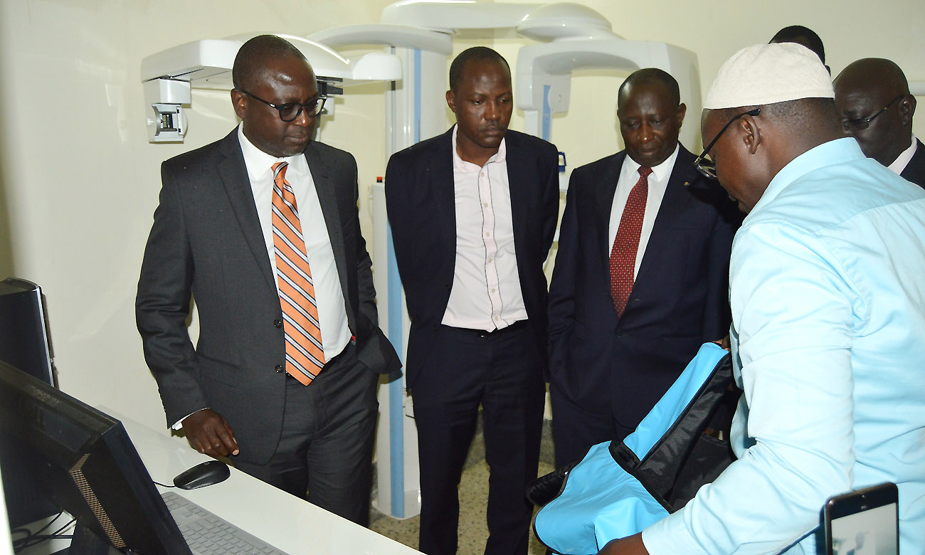 L-R: Dr. Geoffrey Bataringaya, Acting DVCAA-Dr. Christopher Mbazira, Principal CHS-Prof. Charles Ibingira and other officials listen to Member of Staff (Right) demonstrate how the X-Ray Machine (background) donated by the Bataringaya Foundation works on 20th November 2019, Dental Hospital and School, Northcote Road, Makerere University, Kampala Uganda.