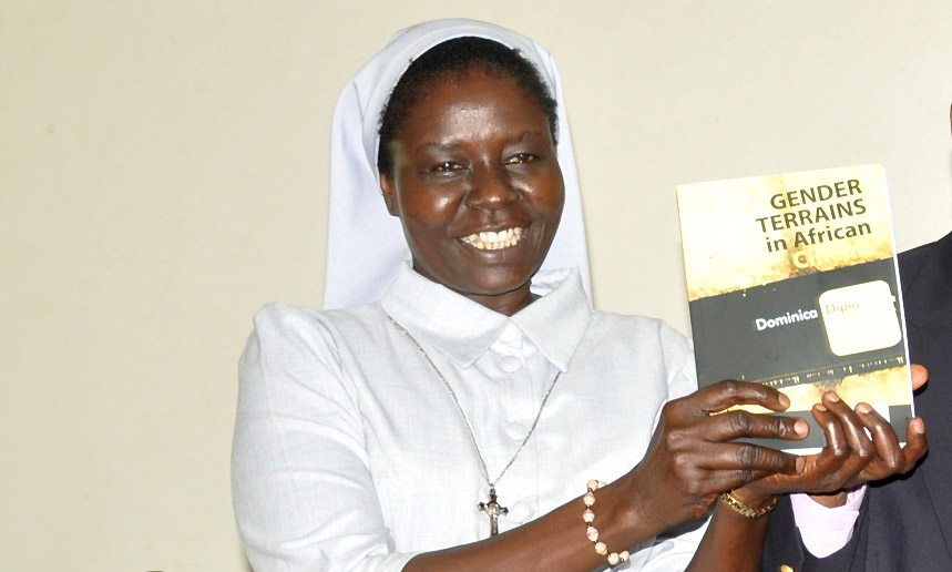 Prof. Sr. Dominica Dipio shows off one of her books "Gender Terrains in African Cinema" during the launch event on 31st October 2014, Makerere University, Kampala Uganda.