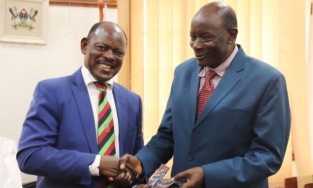 The Vice Chancellor-Prof. Barnabas Nawangwe (Left) hands over a Mak necktie to Prof. Issac J. Minde (Right) after the meeting on 4th November 2019, Makerere University, Kampala Uganda