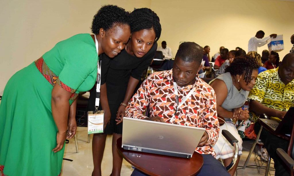 Dr. Susan Balaba Tumwebaze (Left) and a colleague from RUFORUM (Centre) help a male student during the Scientific Data Management training as part of the 15th RUFORUM AGM, being held at the University of Cape Coast (UCC) in Ghana from 2-6 December, 2019.
