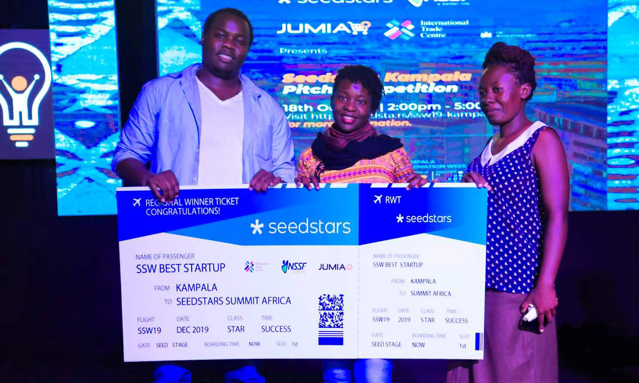The Teheca team L-R; Ruyonga Daniel, Namugambe Asha and Namirimu Oliver holding a dummy ticket to the Seedstars regional competition after emerging winners of the Kampala Event on 19th October 2019, Kololo Independence Grounds, Uganda. Teheca, a mobile app to connect young mothers and pregnant women to nurses will represent Uganda and the African region at the Seedstars Summit 2020 in Lausanne, Switzerland. Photo Credit:TEHECA