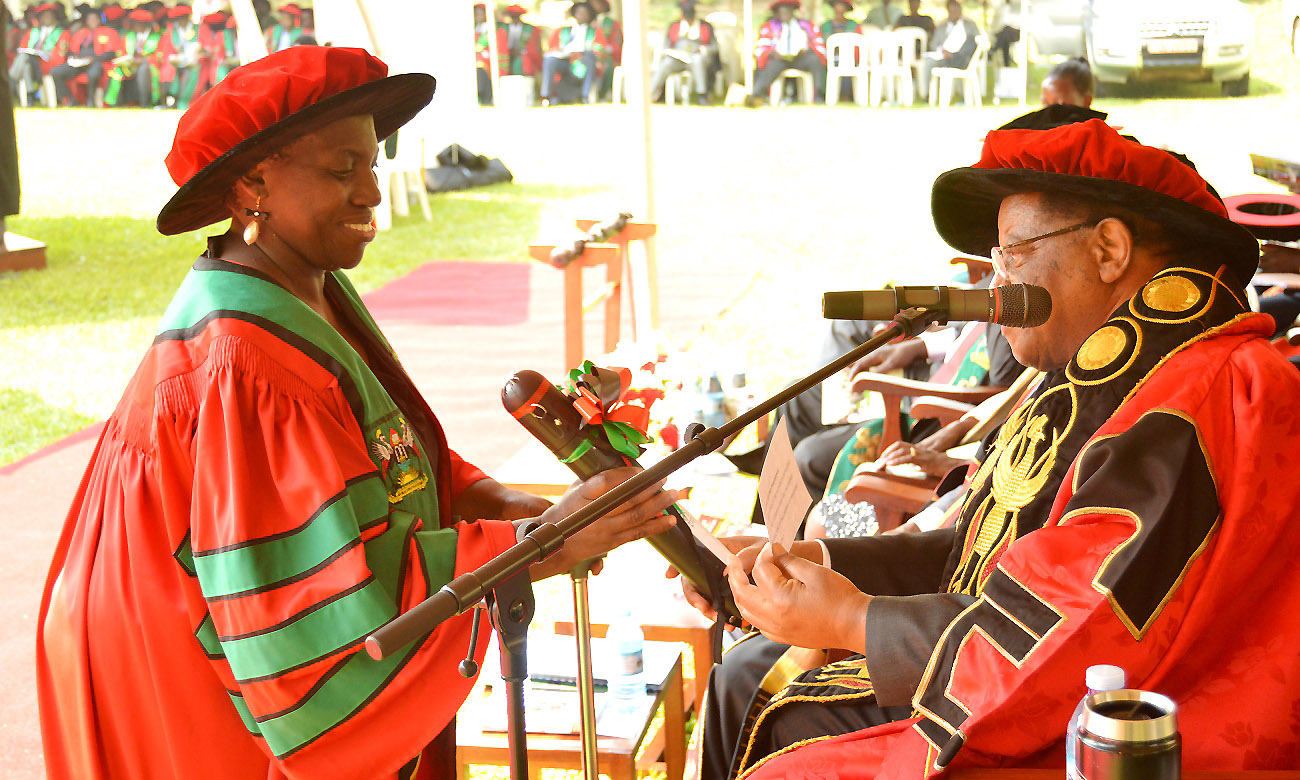 The Chancellor-Prof. Ezra Suruma (Right) hands over the PhD Cylinder to CHS' Dr. Najjuka Christine Florence during Day 1 of the 70th Graduation Ceremony, 14th January 2020, Makerere University, Kampala Uganda.