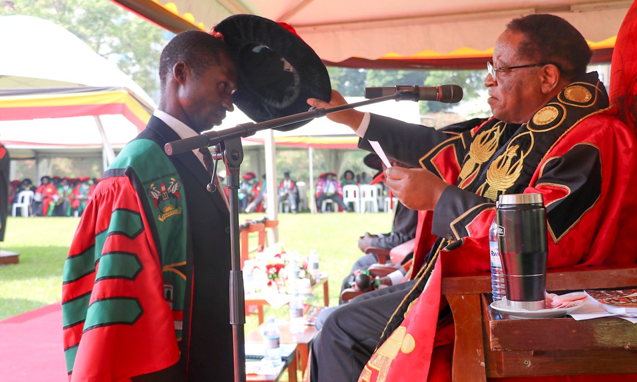 The Chancellor-Prof. Ezra Suruma (Right) confers a PhD upon MakSPH's Mr. Godfrey Bwire during Day 1 of the 70th Graduation Ceremony, 14th January 2020, Makerere University, Kampala Uganda.