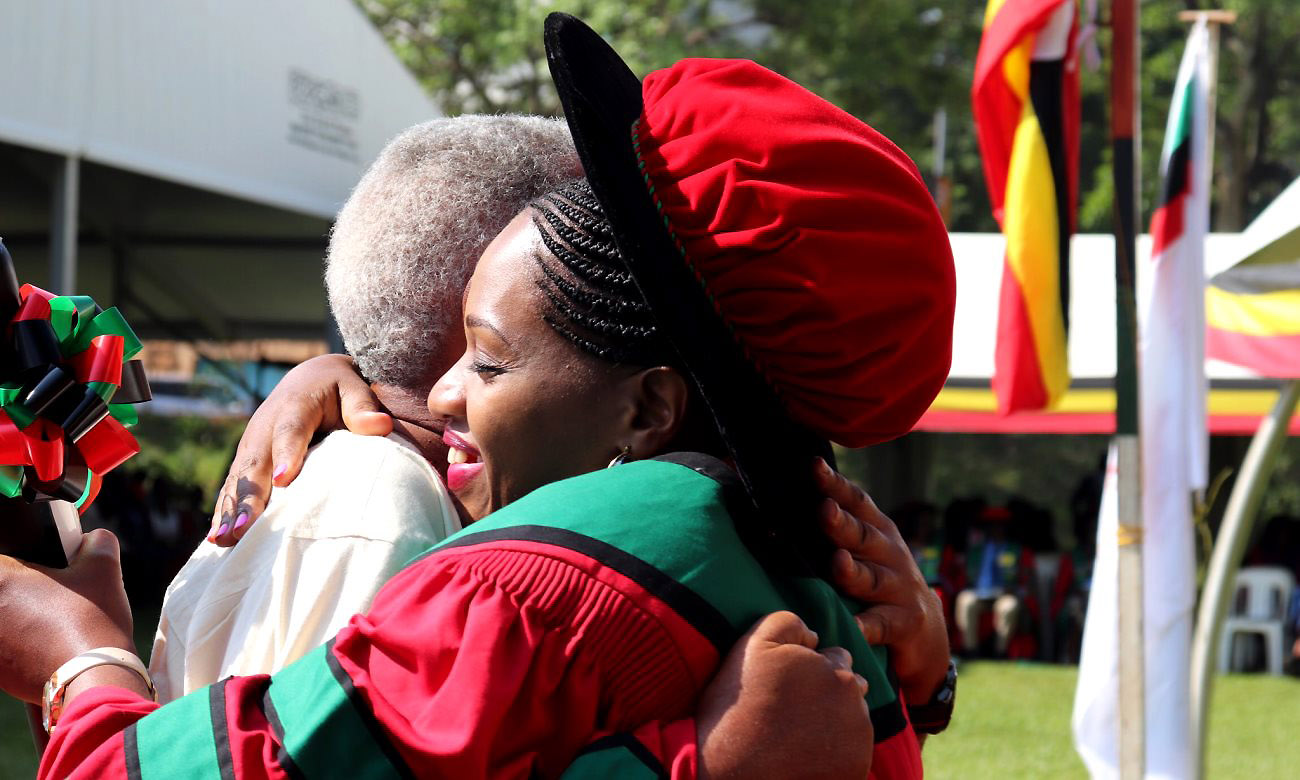 An ecstatic PhD Graduand is hugged by her equally overjoyed father shortly after receiving her award during Day 2 of the 70th Graduation Ceremony, 15th January 2020, Freedom Square, Makerere University, Kampala Uganda.