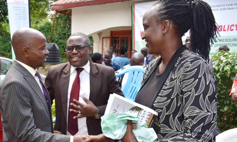 The Director EfD-Mak Centre Assoc. Prof. Edward Bbaale (Left) interacts with Wakiso District LCV Chairman, Mr. Bwanika Matia Lwanga (Centre) and Vice Chairperson Hon. Betty Naluyima (Right) during the Policy Dialogue on 9th December 2019, Wakiso, Uganda.
