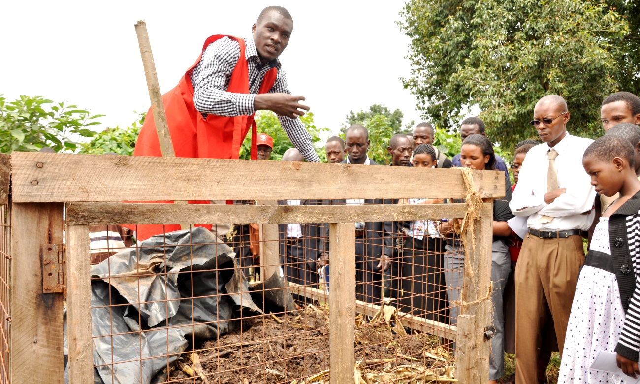 A student from the Department of Agribusiness and Natural Resources Economics demonstrates compost making during an Internship Exhibition on 8th August 2014, MUARIK, CAES, Makerere University, Wakiso Uganda.