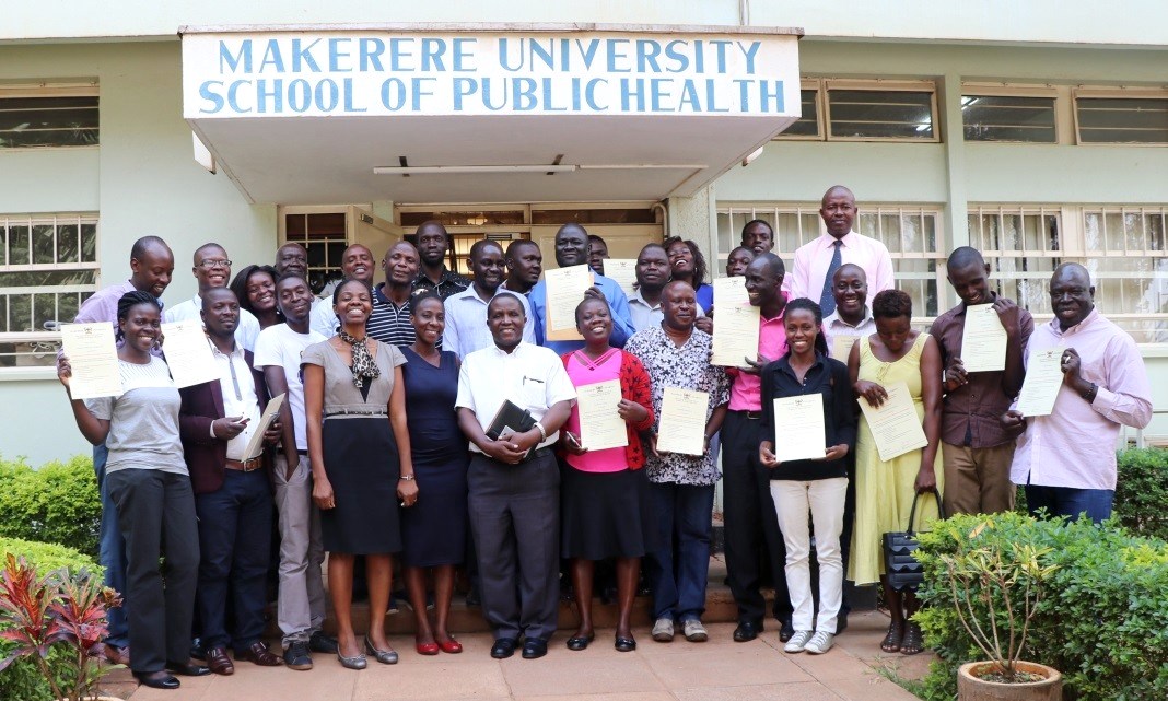 The Former Chair, Department of Epidemiology and Biostatistics-Dr. Nazarius Mbona Tumwesigye (6th L) and the Head of Department, Disease Control and Environmental Health-Dr. Esther Buregyeya (4th L) pose for a group photo with participants following their graduation from the WASH Programme on 20th July 2018, Makerere University School of Public Health, Mulago Campus, Kampala Uganda.