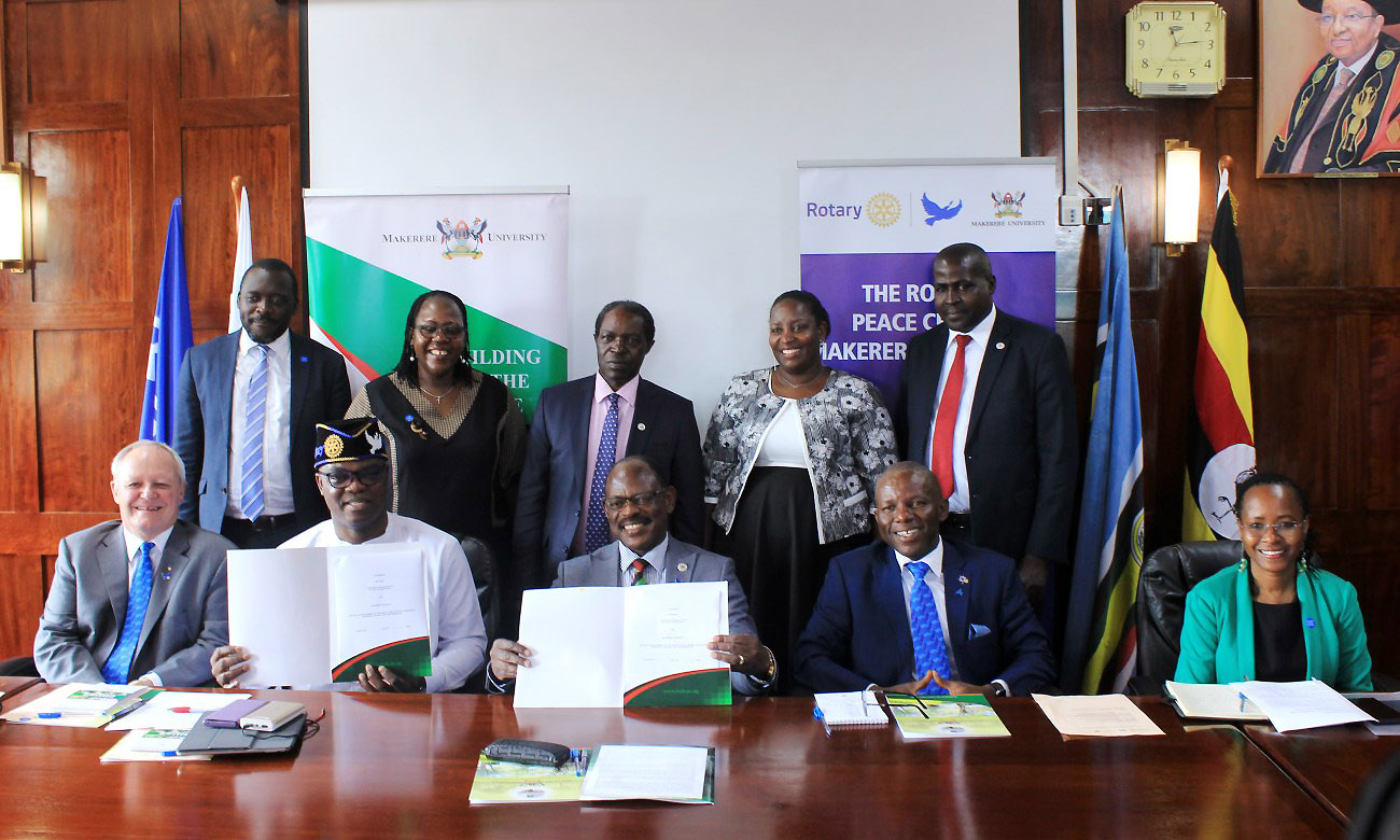 Seated: The VC-Prof. Barnabas Nawangwe (C) & Rotary VP- Olayinka Babalola (2nd L) show off the signed MoU as R-L: Dr. Sarah Ssali, DG Francis Xavier Sentamu, Bryn Styles & Backrow L-R: Mr. Yusuf Kiranda, Dr. Josephine Ahikire, Prof. William Bazeyo, Dr. Hellen Nkabala & Mr. Henry Mwebe witness on 9th January 2020, Makerere University, Kampala Uganda.